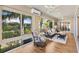 Spacious sunroom with comfortable seating and lots of natural light at 973 Baisley Trl, The Villages, FL 32162