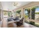 Bright sunroom with expansive windows and comfortable seating at 973 Baisley Trl, The Villages, FL 32162
