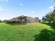 Spacious backyard with a screened-in patio, perfect for enjoying the outdoors in comfort and style at 10069 Lake Miona Way, Oxford, FL 34484