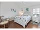 Charming bedroom with a coastal theme, featuring hardwood floors and a ceiling fan at 10069 Lake Miona Way, Oxford, FL 34484