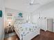 Inviting bedroom with hardwood floors, ceiling fan, and coastal-themed décor at 10069 Lake Miona Way, Oxford, FL 34484