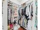 Walk-in closet with custom shelving and hanging space for organized storage at 10069 Lake Miona Way, Oxford, FL 34484