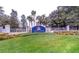 Lakeside Landings community entrance with manicured landscaping, signage, and decorative patriotic banners at 10069 Lake Miona Way, Oxford, FL 34484