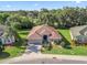 Beautiful one-story home featuring a brick paved driveway, well maintained landscaping, and a neutral color palette at 10069 Lake Miona Way, Oxford, FL 34484