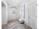 Open foyer featuring decorative art, a modern bench, and a bright entryway with views of the front door at 10069 Lake Miona Way, Oxford, FL 34484