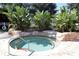 Relaxing hot tub surrounded by lush landscaping and stone, ideal for a tranquil escape at 10069 Lake Miona Way, Oxford, FL 34484