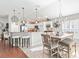 Lovely kitchen and dining area with white cabinetry, tiled flooring, and modern lighting fixtures at 10069 Lake Miona Way, Oxford, FL 34484