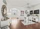 Bright living room showcasing hardwood floors, a neutral color palette and an arched entryway at 10069 Lake Miona Way, Oxford, FL 34484