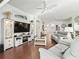 Spacious living room with hardwood floors, modern furniture, and neutral colors throughout the area at 10069 Lake Miona Way, Oxford, FL 34484