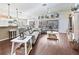 Bright, open living room area with hardwood floors leading to outdoor seating at 10069 Lake Miona Way, Oxford, FL 34484