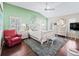A primary bedroom with light green walls, shutters, vaulted ceiling, and neutral decor at 10069 Lake Miona Way, Oxford, FL 34484