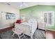 A primary bedroom with light green walls, shutters, vaulted ceiling, and neutral decor at 10069 Lake Miona Way, Oxford, FL 34484