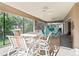Enclosed patio with ample seating and open views of the well-maintained backyard at 10069 Lake Miona Way, Oxford, FL 34484