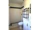 Updated bathroom featuring a tiled shower with a decorative accent and modern vanity with ample storage at 104 N Oakland Ave, Clermont, FL 34715