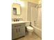 This bathroom features a tiled shower/tub combo with updated fixtures and a modern vanity at 104 N Oakland Ave, Clermont, FL 34715