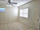 Bright room featuring tile floors, natural light, and ceiling fan at 104 N Oakland Ave, Clermont, FL 34715