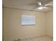 This bedroom has tile floors, a ceiling fan and natural light from the window at 104 N Oakland Ave, Clermont, FL 34715