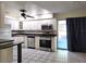 Stylish kitchen featuring modern stainless steel appliances and patterned flooring at 104 N Oakland Ave, Clermont, FL 34715