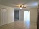 Neutral living area features tile floors, a ceiling fan, and ample natural light at 104 N Oakland Ave, Clermont, FL 34715
