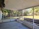 View of the screened porch, featuring a concrete floor and views of the spacious backyard at 104 N Oakland Ave, Clermont, FL 34715