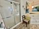 Bathroom featuring shower, soaking tub, tile floors, and art at 104 Valencia Cv, Leesburg, FL 34748