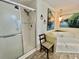 Bathroom featuring shower, soaking tub, tile floors, and art at 104 Valencia Cv, Leesburg, FL 34748