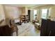 Cozy bedroom featuring tile floors, a comfortable sitting area, and natural light at 104 Valencia Cv, Leesburg, FL 34748