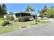 Charming home with a lush front yard, well-manicured bushes, and a sunny curb appeal at 104 Valencia Cv, Leesburg, FL 34748