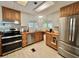 Functional kitchen showcases ample counter space, and stainless steel appliances at 104 Valencia Cv, Leesburg, FL 34748