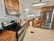 Bright kitchen featuring stainless steel appliances, stylish range hood and wooden countertops at 104 Valencia Cv, Leesburg, FL 34748