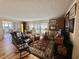 Spacious living room features hardwood floors, warm lighting and sliding glass doors at 104 Valencia Cv, Leesburg, FL 34748