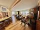 Open living space featuring wood floors, neutral walls, and a comfortable sitting area with recliners and bright natural light at 104 Valencia Cv, Leesburg, FL 34748