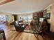 Spacious living room features hardwood floors, warm lighting and sliding glass doors at 104 Valencia Cv, Leesburg, FL 34748
