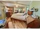 Main bedroom featuring wood floor and ceiling fan at 104 Valencia Cv, Leesburg, FL 34748