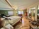 Main bedroom featuring wood floor and a ceiling fan at 104 Valencia Cv, Leesburg, FL 34748