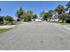 A peaceful street lined with well-maintained homes and lush greenery with a clear blue sky at 104 Valencia Cv, Leesburg, FL 34748