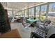 Sunroom featuring tile floors, many windows, and comfortable seating at 104 Valencia Cv, Leesburg, FL 34748