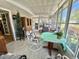 Sunroom featuring tile floors, many windows, and comfortable seating at 104 Valencia Cv, Leesburg, FL 34748