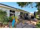 Charming back patio with ample seating and lush landscaping for relaxing outdoors at 106 Baytree Blvd, Tavares, FL 32778