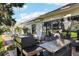 Outdoor patio with a grill, seating, and mature landscaping at 106 Baytree Blvd, Tavares, FL 32778