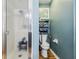 Bathroom with a shower, toilet, and shelving unit at 106 Baytree Blvd, Tavares, FL 32778