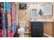 Bathroom featuring a shower with colorful curtain, toilet and large mirror with vanity lighting at 106 Baytree Blvd, Tavares, FL 32778