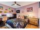 Charming bedroom featuring a unique bedding design, light purple walls, and stylish decorations at 106 Baytree Blvd, Tavares, FL 32778