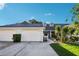 Charming single-story home with a two-car garage, well-maintained landscaping, and inviting curb appeal at 106 Baytree Blvd, Tavares, FL 32778