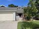 Charming home featuring an attached garage, tidy landscaping, and a cozy front porch with rocking chairs at 106 Baytree Blvd, Tavares, FL 32778