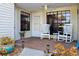 Charming porch with white rocking chairs, a ceiling fan, and decorative potted plants at 106 Baytree Blvd, Tavares, FL 32778