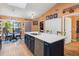 Open kitchen with a large island, breakfast bar, and ample natural light from nearby window at 106 Baytree Blvd, Tavares, FL 32778