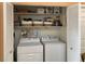 Laundry room with washer, dryer, shelving, and ample space for storage at 106 Baytree Blvd, Tavares, FL 32778