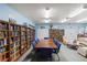 Inviting library area with extensive bookshelves, a large table, and comfortable seating for reading and studying at 106 Baytree Blvd, Tavares, FL 32778