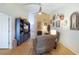 Bright living room with wooden floors, TV and decor for comfortable living at 106 Baytree Blvd, Tavares, FL 32778